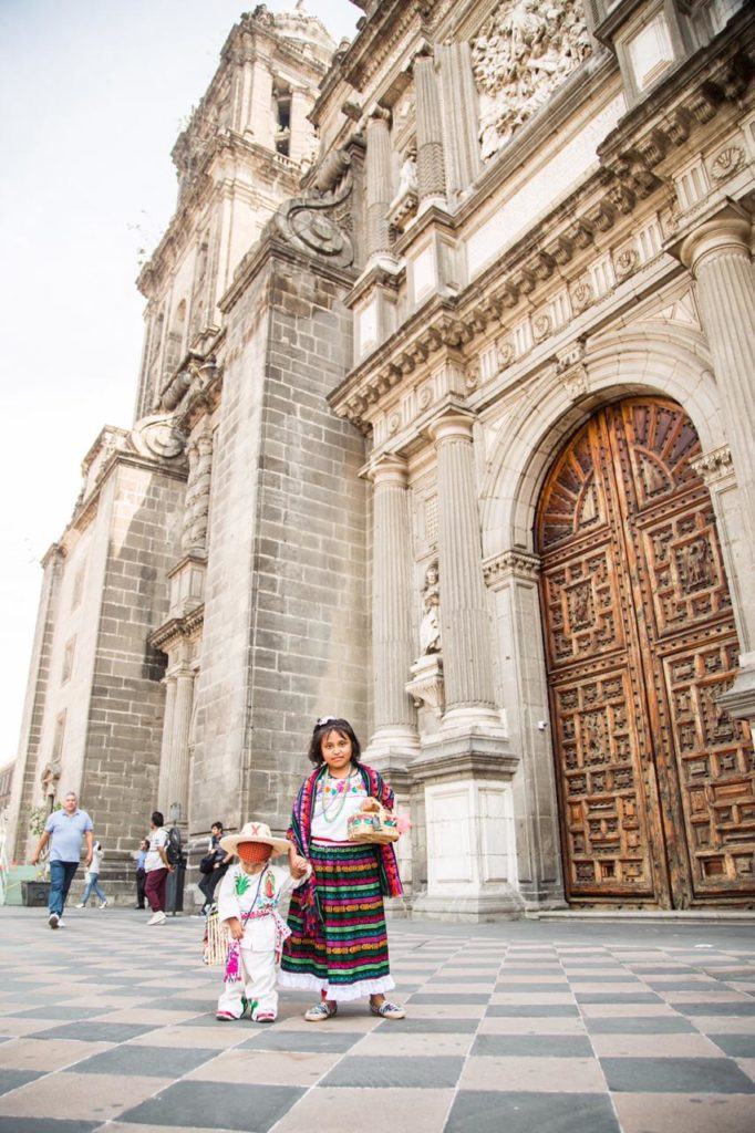 Dos niños posan vestidos de indígenas a las afueras de la Catedral de México. Foto: María Langarica